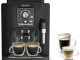 two cups of coffee in front of a coffee machine