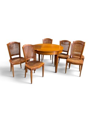 six chairs and a table with a wooden table top
