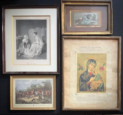 many framed pictures on the wall of this room