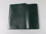 a close up of a black leather wallet on a white surface