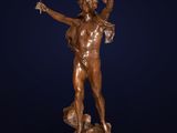a bronze statue of a man holding a bird in his hand