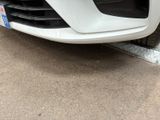 a close up of the front bumper of a white car