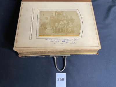 an old photo of a group of people sitting in a room