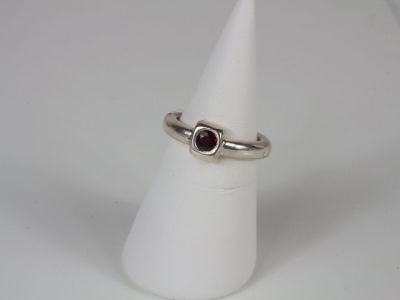 a close up of a ring on a cone on a white surface