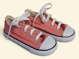 pink converse shoes with white laces on a white background