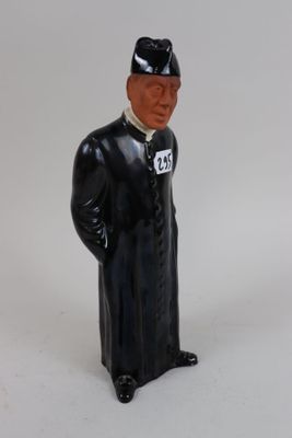 a figurine of a man in a black coat and hat