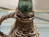 a glass table with a vase on it and a rope wrapped around it