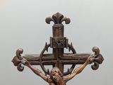 a statue of jesus on a cross on a pedestal