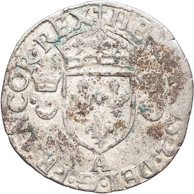 an old silver coin with a shield on it