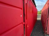 two red shipping containers lined up next to each other