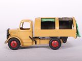 a yellow toy truck that is sitting on a white surface
