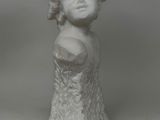 statue of a woman with a breast on a white background