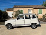 a small white car parked in front of a house