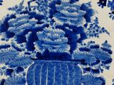 a blue and white plate with a bouquet of flowers on it