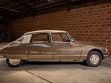 a brown car parked in a garage next to a brick wall