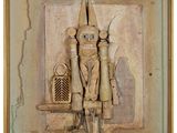 an image of a wooden carving of a man with a hat and a knife