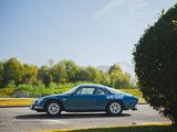 a blue car that is driving down the street