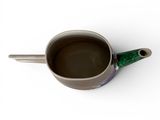 a cup of coffee on a white surface with a green handle