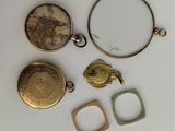 three gold and silver lockes, a ring, and a ring with a picture of a woman