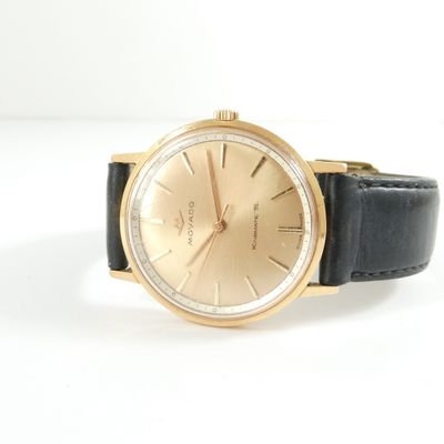 an image of a close up of a wrist watch on a white surface