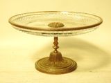 a glass cake plate on a gold stand