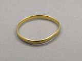 a close up of a gold ring on a white surface