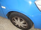 a blue car that is parked on the side of the road