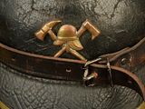 a close up of a helmet with two crossed axes on it
