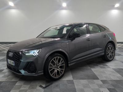 a grey audi qx parked on a checkered tile floor