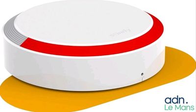 a close up of a white and red device on a yellow surface