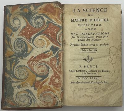 un livre ouvert sur lequel est dessiné un motif de volutes