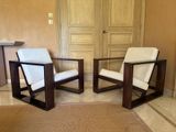 two chairs that are sitting next to each other in a room