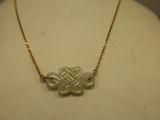 an image of a necklace with a knot on it