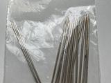 a bunch of pins and needles in a bag