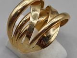 a close up of a gold ring on a white surface