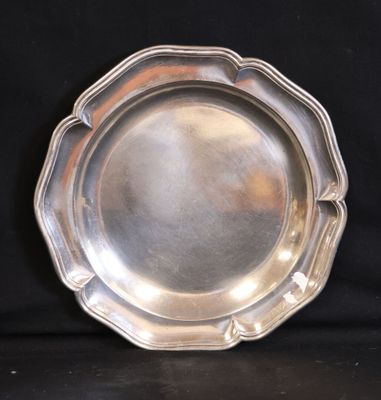 a silver plate that is sitting on a black table