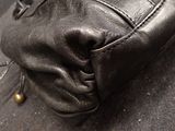 a close up of a pair of black shoes on the ground
