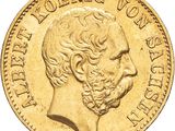 a close up of a gold coin with a man ' s face on it