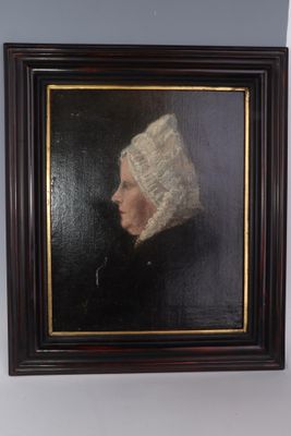 painting of a woman in a white bonnet in a dark wood frame