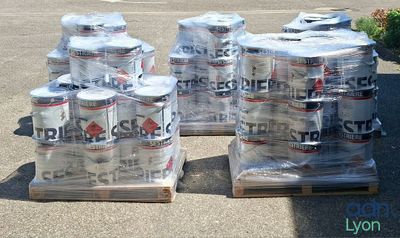 several cans of beer are stacked on pallets in a parking lot