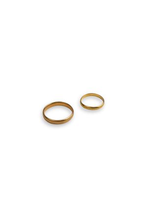 a pair of gold wedding rings on a white background