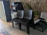 two chairs and a table in a room next to a refrigerator