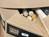 a cardboard box full of supplies sitting on the ground