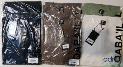three pairs of men ' s shirts in plastic bags on a table