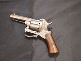 gun on a black cloth with a wooden handle on a table