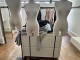 three mannequins on display in a clothing store