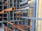 a lot of pipes that are stacked on the side of a building