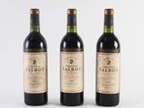 three bottles of red wine sitting next to each other on a white surface