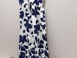 a dress hanging on a hanger next to a pile of clothes