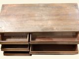a wooden table with drawers on top of it